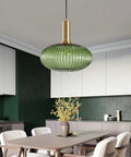 Industrial Vintage Glass Pendant Lighting With Brass Finish For A Dope Modern Retro Look Green Glass Shade in kitchen setting.