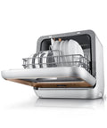 Hassle Free Plug And Play Slick Countertop Dishwasher Fully Automatic Mini Desktop Cleaner with plates in silver wire rack.