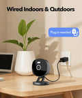 2K Wired Security Camera For Indoor And Outdoor Use With IP65 Weatherproof, Color Night Vision, shown plugged in on a desk.