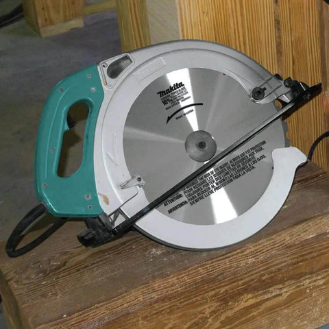 Beefy 15 Amp Electric Circular Saw With 2300 Rpm Motor And Quick Electric Brake resting on a wooden surface.