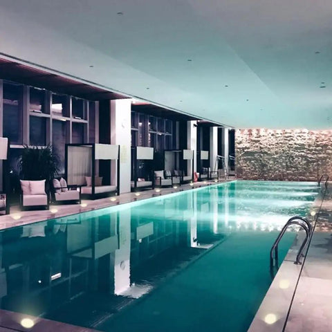 Indoor pool area with soft lighting and seating, showcasing 3W Low Voltage LED Landscape Lights 12 Pack With Wire Connectors