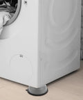 White washing machine with Anti Skid Washer Foot Mats 4 Piece Set with Height Adjustable Vibration Pads for Washing Machines installed.