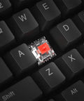 Close-up of red switch on Full Size Mechanical Gaming Keyboard Featuring Top Tier Rgb Lighting And Snappy Red Switches.