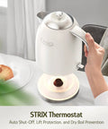 Person holding 1.7L Electric Kettle With Stainless Steel Interior, BPA-Free, 1200W Fast Boil, Cordless With Rotational Base, Automatic Shut Off, One-Touch LED, Pearl White on a tabletop with breakfast.
