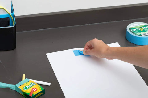 Person using Blue Double Sided Duct Tape Roll 1.4 Inch By 12 Yards With Aggressive Natural Rubber Adhesive on paper
