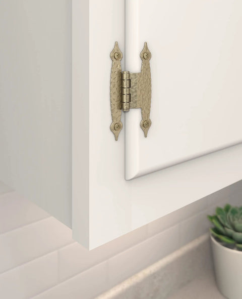 Smooth Swinging Offset Cabinet Hinges With Slick Golden Champagne Finish installed on a white cupboard door.