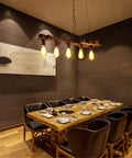 Dope Bronze Linear Island Light With Guitar Shade, Industrial Farmhouse Ceiling Fixture in a dining room over a wooden table