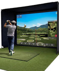 Golfer using Complete Golf Practice Backdrop Enclosure Gear with poles, corner connectors, netting, and impact screen indoors.