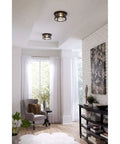 Two Light Outdoor Flush Mount Light In Antique Bronze With Clear Glass Diffuser, Farmhouse Vibe, installed in home interior.
