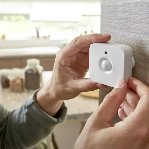 Person installing Indoor Smart Motion Sensor 2 Pack With Daylight Sensing Auto On When You Roll In And Auto Off When You Roll Out