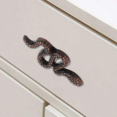 Snake Shaped Cabinet Knobs And Drawer Pulls In Zinc Alloy With Ancient Red Bronze Finish on white cabinet drawer