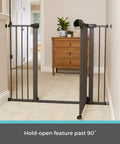 Extra Tall And Wide Pressure Mounted Baby Gate for Doorways in graphite finish, adjustable 29.75 to 52 inches wide, shown in hallway.