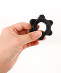 Hand holding a single black clip from the Two Pack Black Plastic Barbell Clip Collars For 1 Inch Bars Portable And Versatile Weightlifting Clips