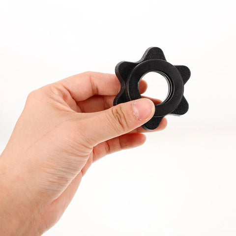 Hand holding a single black clip from the Two Pack Black Plastic Barbell Clip Collars For 1 Inch Bars Portable And Versatile Weightlifting Clips