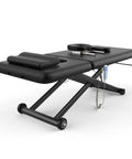 Dolonm Heavy Duty Electric Massage Table With Adjustable Lift And Backrest, wide black cushioned surface, remote control, durable design.