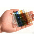 Hand holding Colored Borosilicate Glass Blowing Tubes 8 Piece Set Heavy Duty High Temp Resistant For Industrial Lab And Craft Projects.