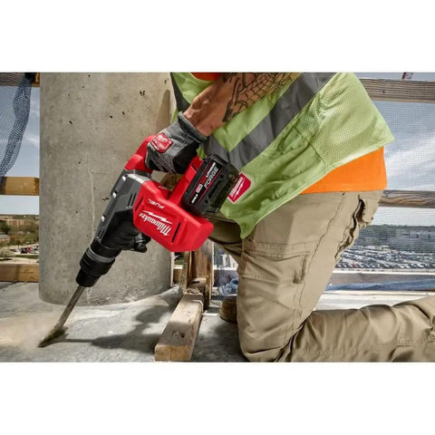 M18 Redlithium Forge 8.0 Ah Rechargeable Battery Pack Featuring Cool Cycle Active Cooling And High Output 12.0 attached to a hammer drill.