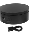 Levemolo Electric Rotating Turntable Display Stand For Jewelry And Watches 360 Degree Spin Base With Anti Skid Design Battery Operated Platform showing black rotating base with USB cable.