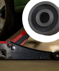 Top Shelf 62mm Floor Jack Rollers For 3 Ton Hydraulic Jacks With 20mm Mounting Holes Durable Steel Replacement Casters on a garage floor.