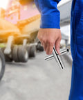 Hand holding a Heavy Duty 4 Way Socket Wrench And Water Valve Key Set for outdoor faucet nuts in a yard.