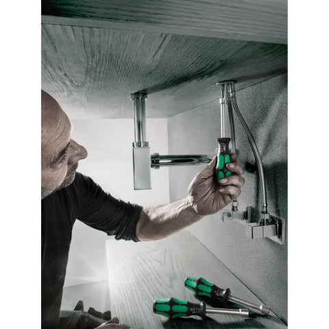 Person using Hollow Nutdriver Set 7 Piece Imperial SAE With Alloy Steel Shanks And Multi Component Handles under sink for repairs