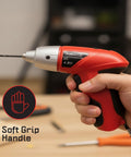 Hand holding red 25-Piece Cordless Screwdriver Set With LED Work Light, soft grip handle, ideal for DIY projects.