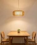 18 Inch Plug in Pendant Light, Boho Hanging Lamp with 15.7FT Light Cord illuminating a wooden dining table and chairs.