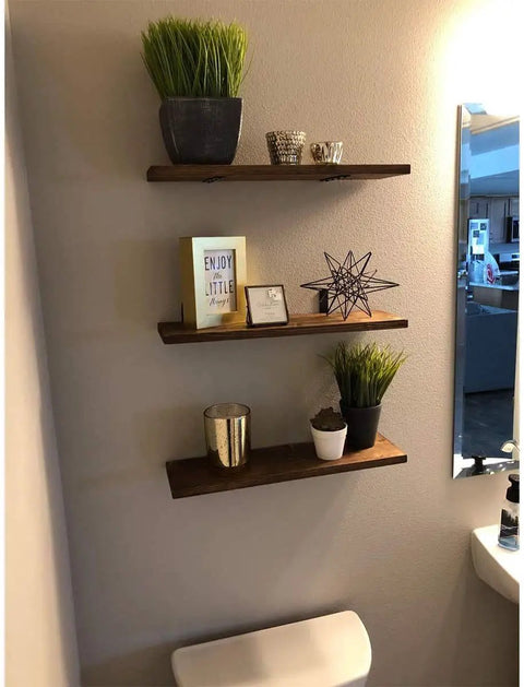 Wall shelves supported by 20 Pack Heavy Duty L Corner Brackets 5x3 Inch Black Shelf Braces for shelves, displaying decor items.