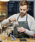 Barista using Upgraded Stainless Steel Pour Over Coffee Filter Dripper For One To Two Cups With 800 Mesh Slow Filter in coffee shop.