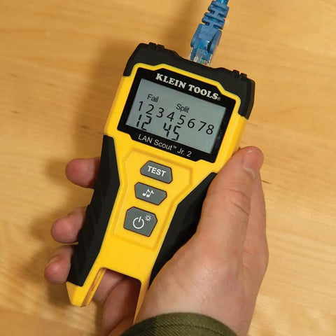 Hand holding yellow LAN Scout Jr 2 Ethernet Cable Tester For CAT5e CAT6 CAT6A RJ45 Cables With Backlit LCD Wiremap
