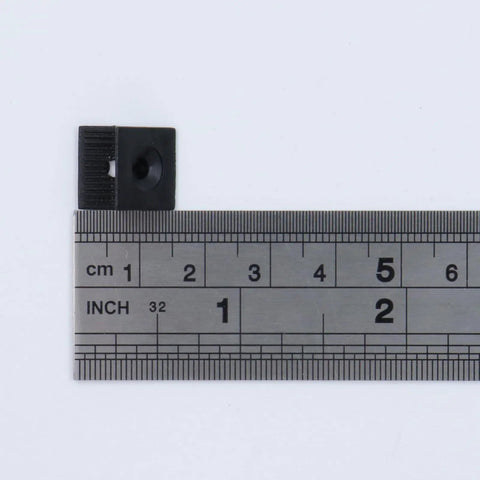 One Hundred Plastic Drawer Wedges With M4 Self Tapping Screws For No Sweat Furniture Repair And Tight Cabinet Slider Fixes Rock Solid Fixing Blocks Quick Household Upkeep Projects, measuring ruler beside a black plastic drawer wedge.
