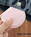 Hand holding light pink compact case of Two Pack Mini Travel Sewing Kit Set, Grab And Go DIY Supplies In A Compact Plastic Case With Threads