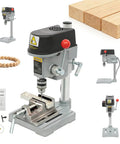 Compact Mini Benchtop Drill Press With Variable Speed Control Up To Sixteen Grand sitting on a workbench with wooden blocks.