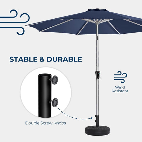 80 Pound Round Patio Umbrella Base With Fillable HDPE Weights For Outdoor Market Umbrellas Sturdy Heavy Duty Stand Fits 1.0 To 1.9 Inch Poles For 6 To 12 Foot Umbrellas Black shown with umbrella pole in windy conditions.