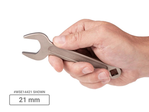 Hand holding a 21 mm wrench from 20-Piece Metric Service Wrench Set with Short-Handled Open-End Wrenches, 15-Degree Angled Heads, 19 To 38 Mm, Heavy-Duty USA-Made Tool Kit For Auto Repairs And Mechanical Projects.