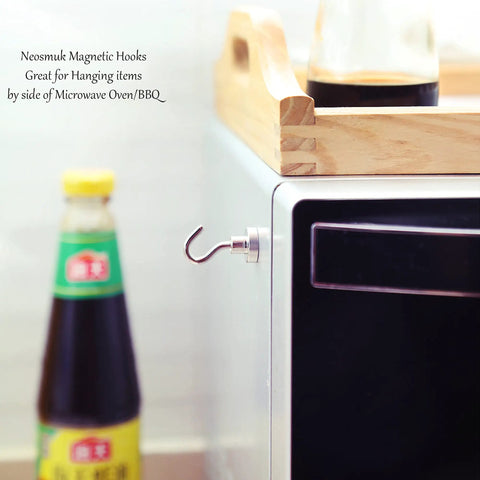 Heavy Duty Magnetic Hooks 30Lb Pack Of 4 For Fridge And Grill Hangers Extra Strong NdFeB Magnets in use on kitchen appliance