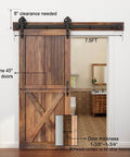 Heavy Duty Boss Grade Black Barn Door Hardware Kit For Wood Sliding Doors Five To Sixteen Feet Flat Track System With Big Spoke Wheel Rollers Carbon Steel Build Dual 3.75 Foot Tracks Ideal For Closet Or Garage Use shown installed on wooden door with measurements