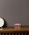 Pink Packing Tape Roll Set For Shipping Boxes, 7 Rolls, 100 Yard Each, Heavy Duty Moisture Resistant Sealing Tape For Moving And Packaging, Built Tough, Easy Tear, Ideal For Boxes Bags And Mailers on table beside clock