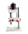 Compact Mini Bench Drill Press Lever Operated Red Tabletop Power Tool For Diy Users Metal Body with red knobs and cylindrical motor.