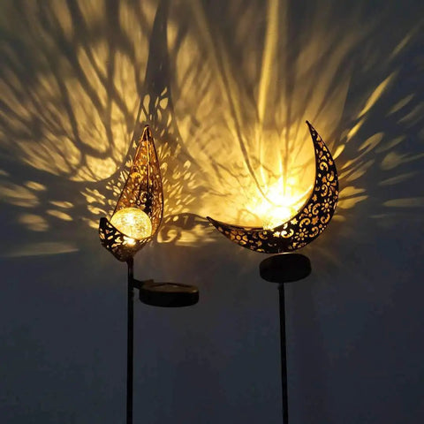 2 Pack Solar Moon Lights With Crackle Glass Globes In Antique Brass Finish casting patterns on wall