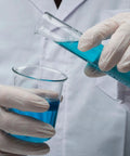 Scientist pouring liquid into Heavy Duty 1000 mL Glass Beaker With White Double Scale Graduation Borosilicate 3.3 Lab Beaker Thick Wall