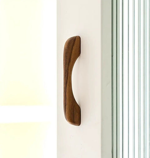Side view of a walnut wood handle on a cupboard. Six Piece Walnut Wood Drawer Pulls Ergonomic Cupboard Handles For Kitchen Cabinets And Dressers Minimalist Solid Wood Hardware Easy DIY Replacement For Wardrobes
