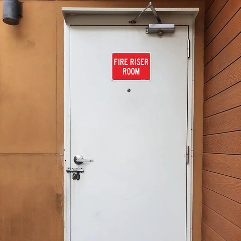 Heavy Duty Rustproof Aluminum Fire Riser Room Signs Two Pack on a white door, 10x7 inches, weatherproof outdoor use.
