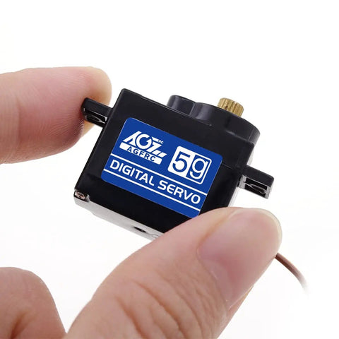 Person holding a small black digital servo marked with '5g', suitable for RC cars and planes, highlighting compact size and lightweight design.
