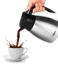 Built Tough 34 Oz Thermal Coffee Carafe With Double Wall Stainless Steel Vacuum Insulation pouring coffee into a white cup.