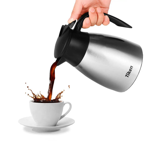 Built Tough 34 Oz Thermal Coffee Carafe With Double Wall Stainless Steel Vacuum Insulation pouring coffee into a white cup.