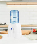 Portable Outdoor Water Dispenser Stand For Camping And Picnics on kitchen countertop, lightweight with blue water jug