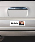 Bumper sticker magnet on rear of car; white panel with i brake for text and a small portrait photo.