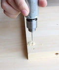 Mini DC 12V Hand Drill Kit With JT0 Chuck drilling into wood surface for precise micro drilling