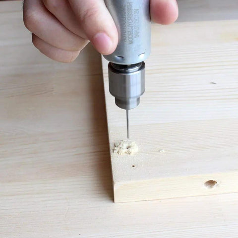 Mini DC 12V Hand Drill Kit With JT0 Chuck drilling into wood surface for precise micro drilling